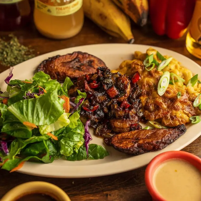 Jerk chicken with green salad, fried plantains and jalapeno mac and cheese.