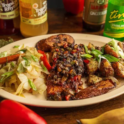 Jerk chicken over rice and peas with cabbage and ripe plantains.