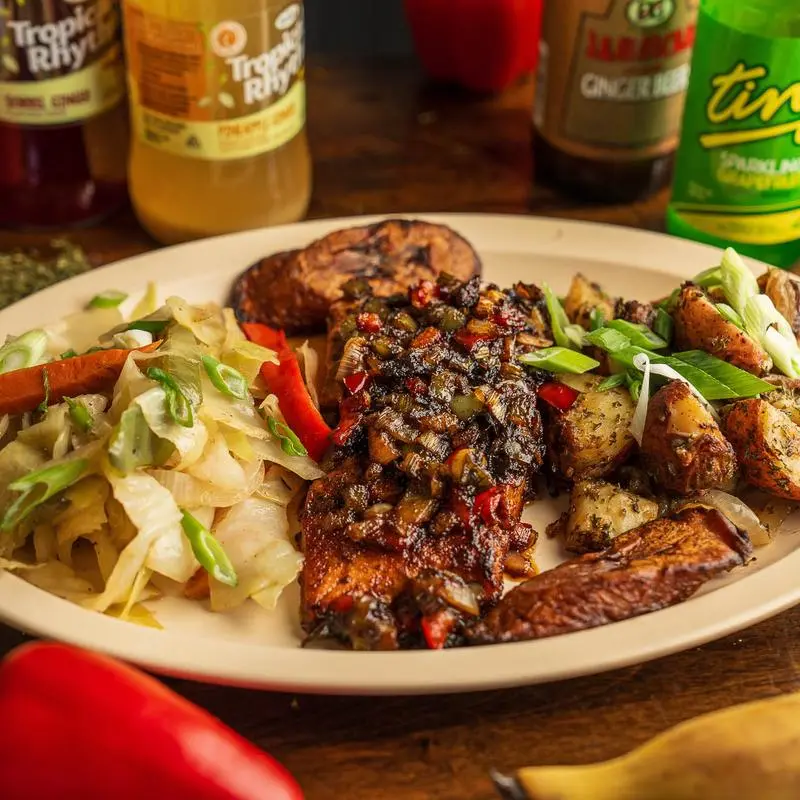 Jerk chicken over rice and peas with cabbage and ripe plantains.